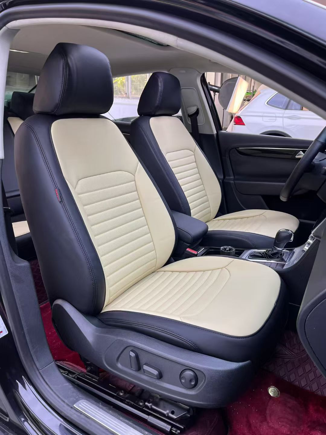 Black and beige custom seat covers installed in a car